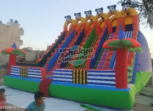 26x24 Ft 6-Lane Mickey Mouse Bouncy Slide – Blue Stripe Walls & Green Base – view 1